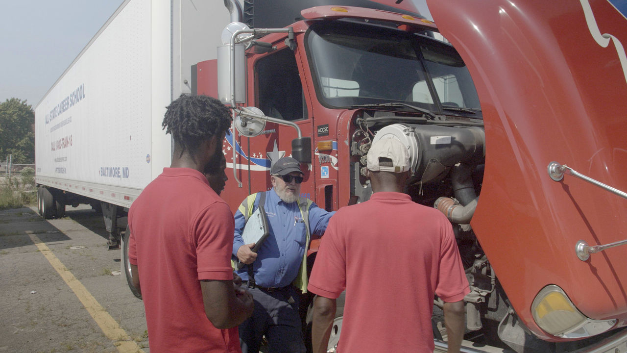 Truck inspection with group discussion at loading dock