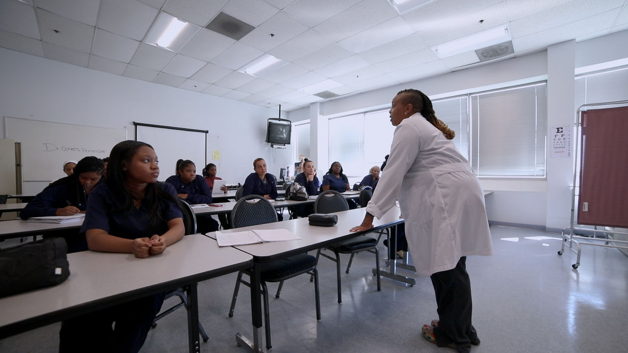 Medical instructor teaching group of adult students