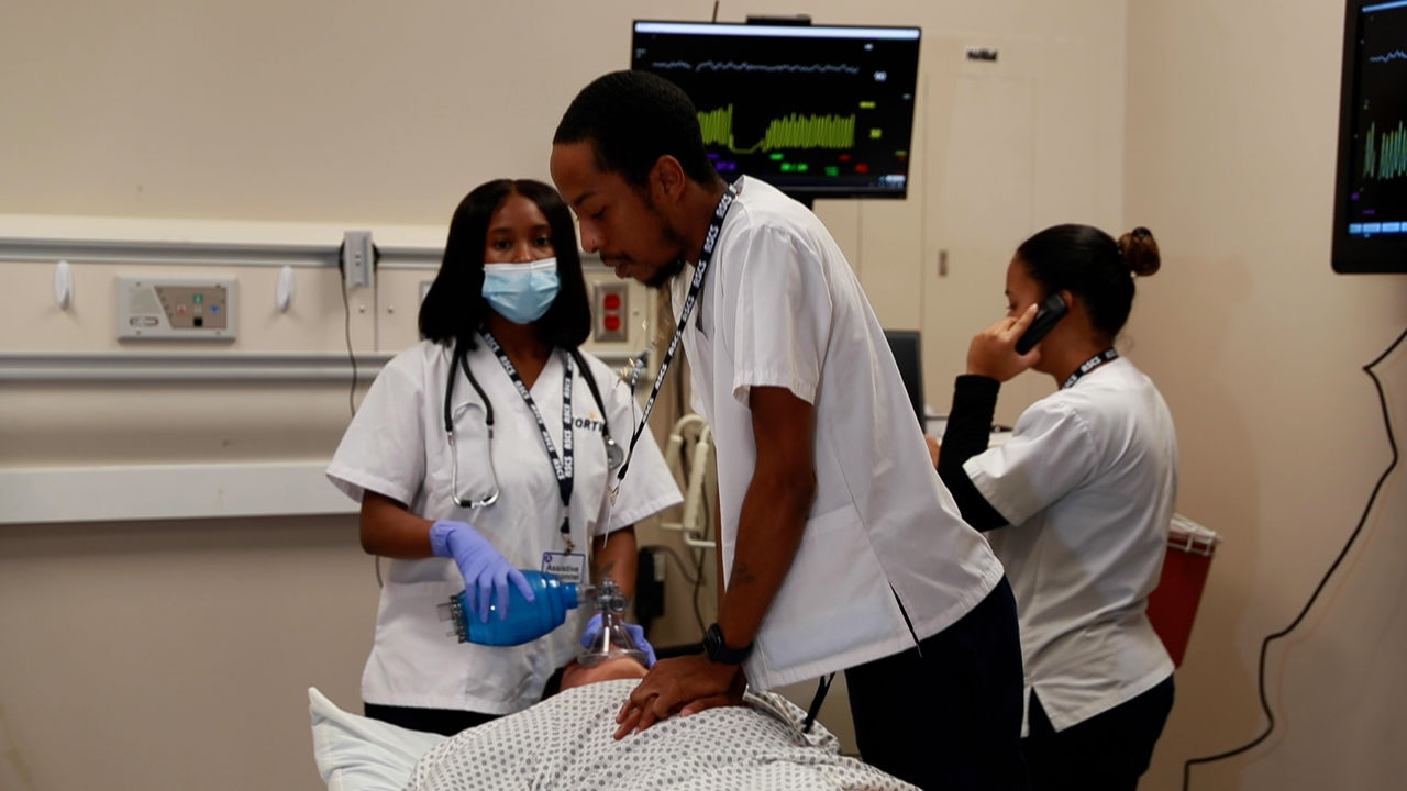 Medical team performing emergency procedure in hospital room